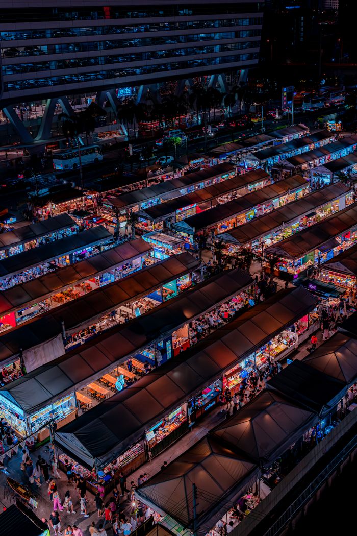 about-us Explore the bustling night market in Bangkok, Thailand, from above.